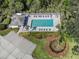 Aerial view of community pool featuring ample seating, lush landscaping, and a shaded cabana at 803 Montrose Dr # 202, Venice, FL 34293