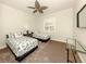 Comfortable bedroom with twin beds, neutral colors, and a decorative ceiling fan at 830 The Esplanade N # 201, Venice, FL 34285