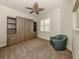 Comfortable bedroom featuring a murphy bed with built-in shelving and a teal chair at 830 The Esplanade N # 201, Venice, FL 34285