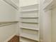 Walk-in closet with adjustable shelving for ample storage space at 830 The Esplanade N # 201, Venice, FL 34285