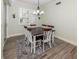 Bright dining area with a wooden table, six chairs, and a stylish rug at 830 The Esplanade N # 201, Venice, FL 34285
