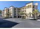Attractive condo building with palm trees, parking, and well-maintained landscaping at 830 The Esplanade N # 201, Venice, FL 34285