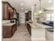 Well-appointed kitchen with dark wood cabinetry, stainless steel appliances, and stylish breakfast bar seating at 830 The Esplanade N # 201, Venice, FL 34285