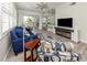 Inviting living room featuring modern decor, an electric fireplace, and seamless flow to the kitchen at 830 The Esplanade N # 201, Venice, FL 34285
