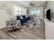Serene living area with a large window, a sliding glass door to balcony, and stylish furnishings at 830 The Esplanade N # 201, Venice, FL 34285