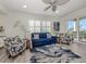 Bright living room with comfortable seating, stylish decor, and access to a balcony with views at 830 The Esplanade N # 201, Venice, FL 34285