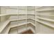 Walk-in pantry with adjustable shelves and an efficient organizational design at 830 The Esplanade N # 201, Venice, FL 34285