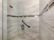 Walk-in shower with glass doors, designer tile, and convenient grab bars at 830 The Esplanade N # 201, Venice, FL 34285