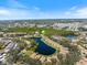 Beautiful aerial of neighborhood featuring many houses surrounding a lake under a blue sky at 832 Saintclair Cir # 832, Venice, FL 34285