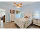 Cozy bedroom featuring a bed, dresser, and complementary nautical decor and natural lighting at 832 Saintclair Cir # 832, Venice, FL 34285