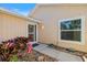 Exterior shot of the front door, window, and front garden with rocks and beautiful landscaping at 832 Saintclair Cir # 832, Venice, FL 34285