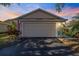 Single car garage featuring a classic door and driveway, offering secure parking with curb appeal at 832 Saintclair Cir # 832, Venice, FL 34285