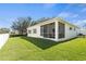 Expansive backyard with lush green lawn and screened-in porch offers tranquil outdoor living at 8603 46Th Avenue W Cir, Bradenton, FL 34210