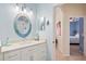 Bathroom vanity with a decorative mirror, ample storage, and a view of the adjacent bedroom at 8603 46Th Avenue W Cir, Bradenton, FL 34210