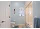 Well-lit bathroom with a glass-enclosed tub and shower, complemented by a nautical-themed window treatment at 8603 46Th Avenue W Cir, Bradenton, FL 34210