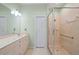 Bathroom featuring double sinks, a walk-in shower, and a linen closet at 8603 46Th Avenue W Cir, Bradenton, FL 34210