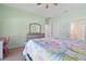 Spacious bedroom with a ceiling fan, dresser, and closet at 8603 46Th Avenue W Cir, Bradenton, FL 34210
