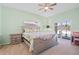 Bedroom featuring a queen-sized bed, sliding glass door, and a nightstand with drawers at 8603 46Th Avenue W Cir, Bradenton, FL 34210