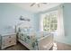 Light-filled bedroom with a nautical theme featuring a large window and comfortable decor at 8603 46Th Avenue W Cir, Bradenton, FL 34210