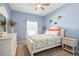 Serene bedroom with light blue walls, a decorative mirror, and a comfortable bed at 8603 46Th Avenue W Cir, Bradenton, FL 34210