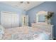 Inviting bedroom with coastal decor, a dresser, and a view of the hallway and closet at 8603 46Th Avenue W Cir, Bradenton, FL 34210