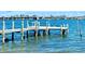 A serene dock on the water provides a peaceful retreat for residents, featuring several birds relaxing on the posts at 8603 46Th Avenue W Cir, Bradenton, FL 34210