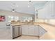 Kitchen featuring stainless steel appliances, white cabinets, and stone countertops at 8603 46Th Avenue W Cir, Bradenton, FL 34210