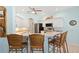 Kitchen featuring white cabinetry, stainless steel appliances, and a breakfast bar with seating for three at 8603 46Th Avenue W Cir, Bradenton, FL 34210