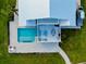 Stunning aerial view of a home featuring a pool, patio with furniture, and lush landscaping at 9061 Kellogg Ln, Venice, FL 34293