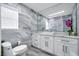 Modern bathroom with stylish tile, a vanity with marble countertop, and a vessel sink at 9061 Kellogg Ln, Venice, FL 34293