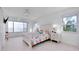 Bright bedroom features water views, a coastal themed decor, and white tile flooring at 9061 Kellogg Ln, Venice, FL 34293