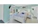 Bright bedroom with white furniture, a king bed and access to a patio with water view at 9061 Kellogg Ln, Venice, FL 34293