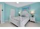Bedroom with white furnishings, light blue walls, and nautical accents at 9061 Kellogg Ln, Venice, FL 34293