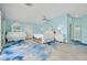 Bedroom with a large mirror, sliding glass door, a decorative bed, and coastal theme at 9061 Kellogg Ln, Venice, FL 34293