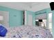 Bright bedroom features a built-in bookcase, a nautical themed bedspread, and an adjacent office space at 9061 Kellogg Ln, Venice, FL 34293