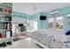 Bright bedroom features a built-in bookcase, a nautical themed bedspread, and an adjacent office space at 9061 Kellogg Ln, Venice, FL 34293