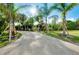 Long private driveway lined with palm trees leads to this secluded and tropical retreat at 9061 Kellogg Ln, Venice, FL 34293