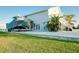 Beautiful home featuring a well-maintained lawn, boat on trailer, and outdoor stair access to the home at 9061 Kellogg Ln, Venice, FL 34293