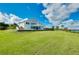 Expansive waterfront home with a large yard, deck, and serene surroundings at 9061 Kellogg Ln, Venice, FL 34293