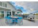 Outdoor dining area on a deck with a grill, overlooking scenic views at 9061 Kellogg Ln, Venice, FL 34293