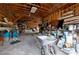 Spacious garage with exposed beams, ample storage, and a vintage wheelbarrow at 9061 Kellogg Ln, Venice, FL 34293
