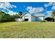 Exterior of a detached garage with white siding and landscaping at 9061 Kellogg Ln, Venice, FL 34293