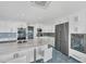 Spacious kitchen featuring a marble island with seating and stainless steel appliances and fixtures at 9061 Kellogg Ln, Venice, FL 34293