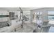 Kitchen with dual islands featuring marble countertops, custom cabinets, and stainless steel appliances at 9061 Kellogg Ln, Venice, FL 34293
