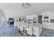 Spacious kitchen with double islands, marble countertops, and stainless appliances, adjoined by a large living area at 9061 Kellogg Ln, Venice, FL 34293