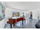 Elegant living room with grand piano, marble floors, and staircase access at 9061 Kellogg Ln, Venice, FL 34293