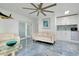 Bright and airy living room with tile flooring, white couches, wet bar, and sliding glass doors at 9061 Kellogg Ln, Venice, FL 34293