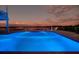 Inviting pool with illuminated waters at dusk and scenic water views at 9061 Kellogg Ln, Venice, FL 34293