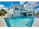 Backyard pool with a covered patio, and a view of the beautifully landscaped outdoor space at 9061 Kellogg Ln, Venice, FL 34293