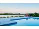 Inviting pool area with lush landscaping, providing a relaxing retreat with views of the water at 9061 Kellogg Ln, Venice, FL 34293